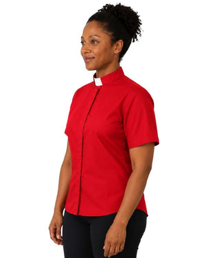 A woman wearing a short-sleeve red clerical shirt with a white collar tab, shown in profile against a plain white background.