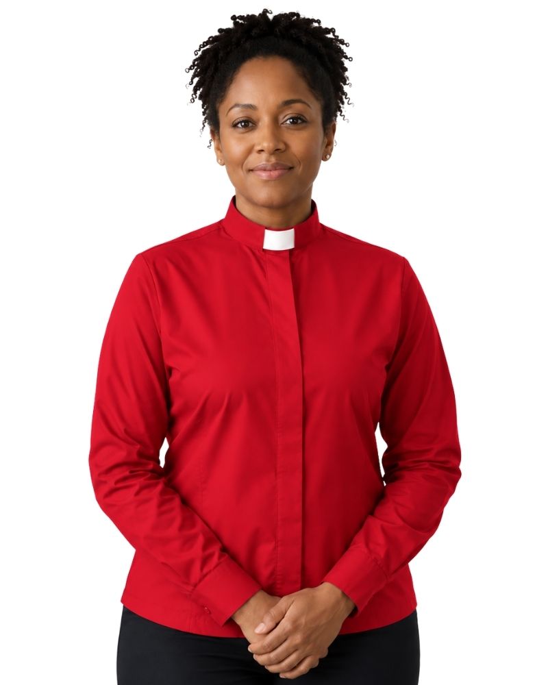 A woman wearing a red long-sleeve clerical shirt with a white collar tab, standing against a plain white background.