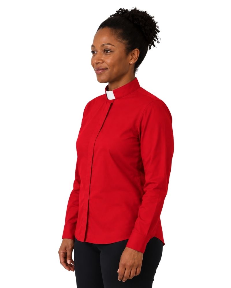 A woman wearing a long-sleeve red clerical shirt with a contrasting white collar, paired with black trousers and a black belt, shown in a side-profile view against a plain white background.