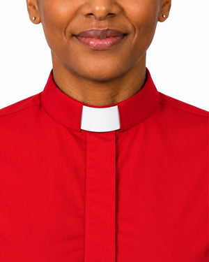 Close-up of a woman wearing a red clerical shirt with a white collar, showing the neck, lower face, and upper chest against a white background.
