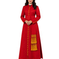 A woman modeling a long red cassock with gold buttons, gold fringe, and a white collar, standing against a plain white background.