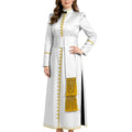 A woman modeling a long white cassock with gold trim, gold buttons, and a gold fringe panel, shown against a plain white background.