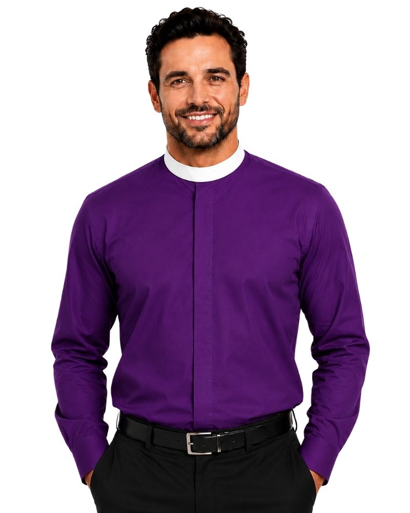 A smiling man wearing a purple long-sleeve clerical shirt with a white mock neck collar, paired with black trousers and a black belt, against a plain white background.