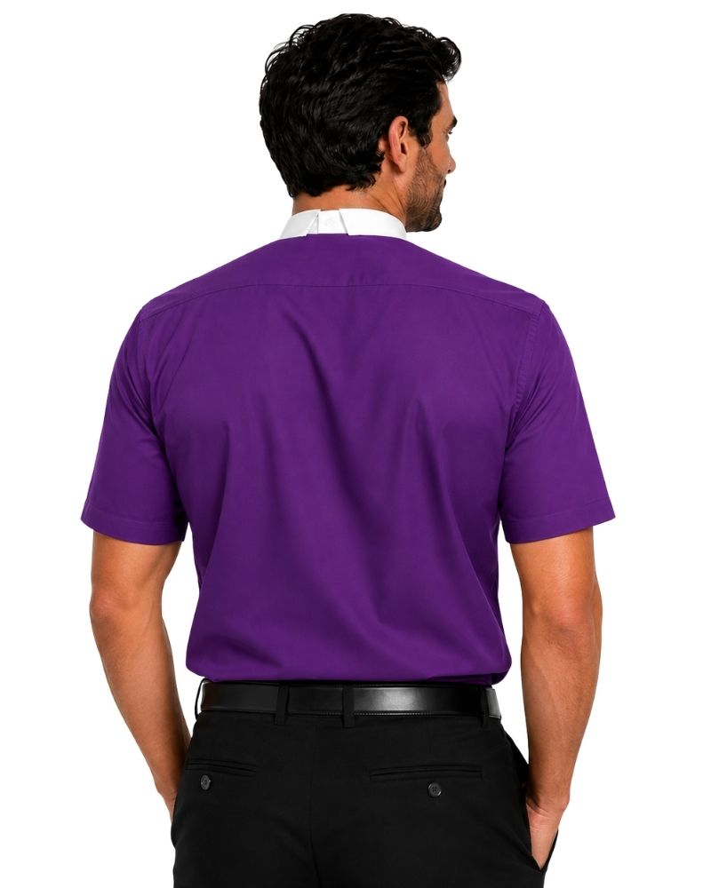 A man viewed from the back wearing a solid purple short-sleeve clerical shirt tucked into black trousers, against a plain white background.