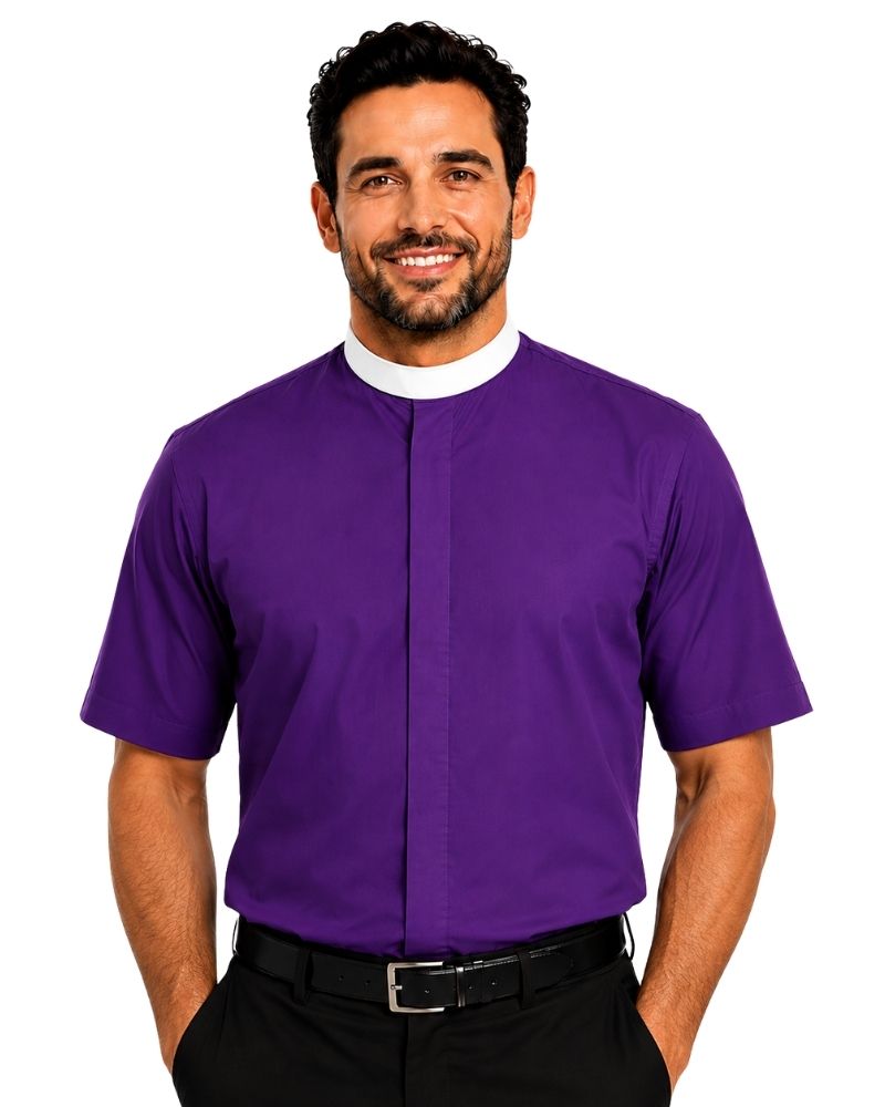 A man viewed from the front wearing a solid purple short-sleeve clerical shirt tucked into black trousers, against a plain white background.