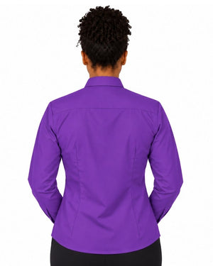A woman viewed from the back wearing a purple long-sleeve clerical shirt and black pants, set against a plain white background.
