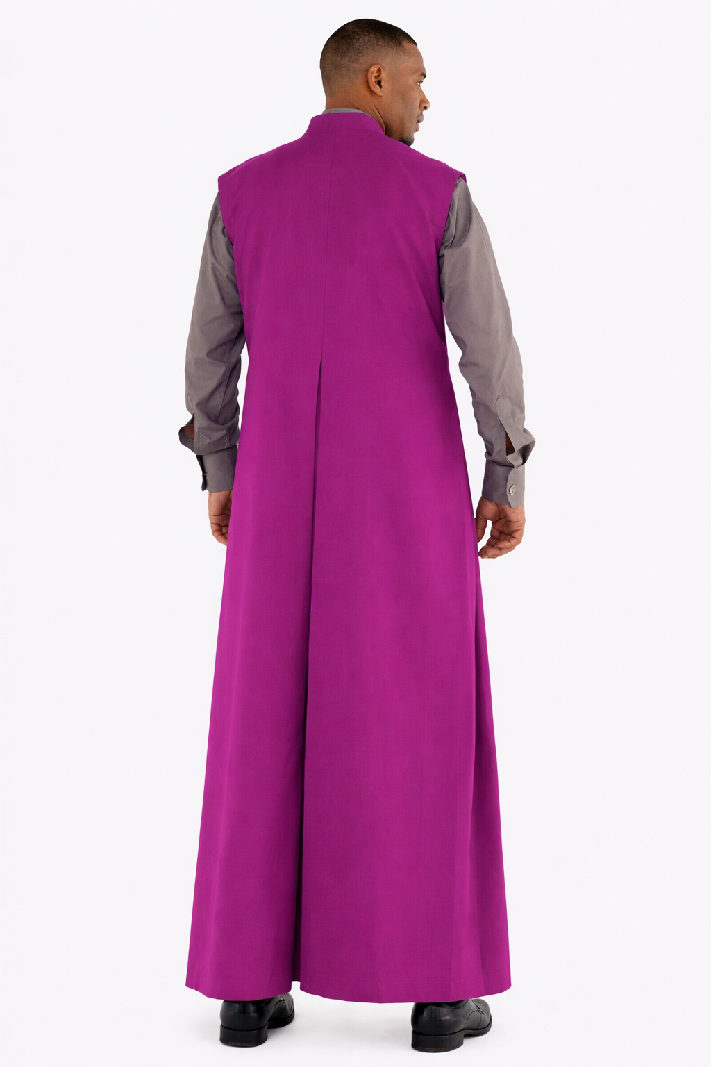 Man wearing a long purple robe over a gray shirt on a white background