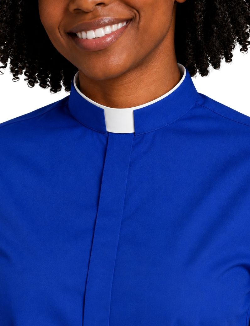 A close-up of a women wearing a royal blue clerical shirt with a white collar, shown against a plain white background.