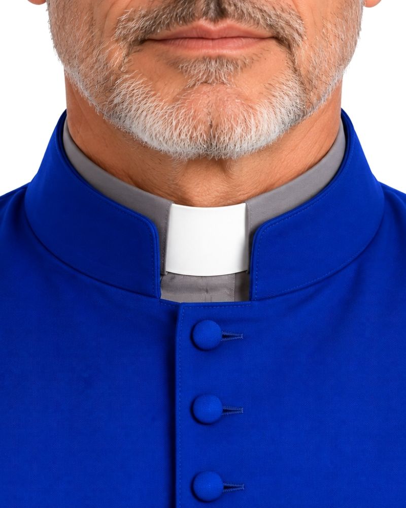 Close-up of a man wearing a Royal Blue Jethro Sleeveless Clergy Robe with a white and gray clerical collar underneath, on a white background.