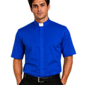 A man wearing a royal blue short-sleeve clerical shirt with a white collar tab, paired with black trousers and a black belt, against a plain white background.