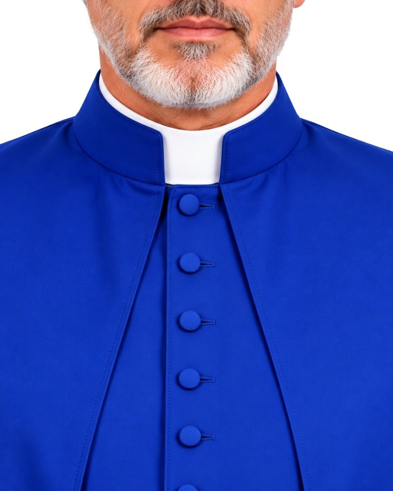 A close-up of a Royal Blue Solomon Cassock For Men With Shoulder Cape with a white collar insert, featuring a high stand-up collar and a front button closure.