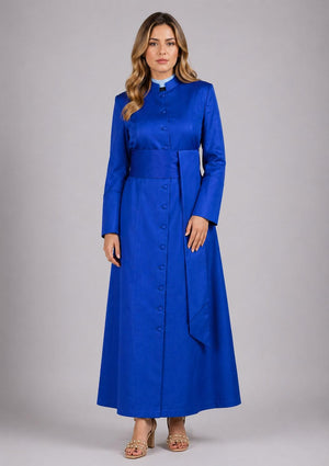 Woman wearing a long blue dress with a belt on a gray background