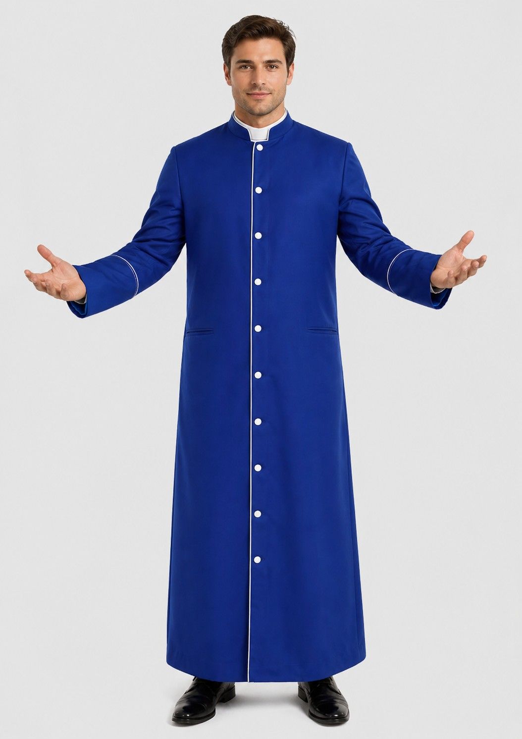 Man wearing a long blue robe with white buttons on a plain background