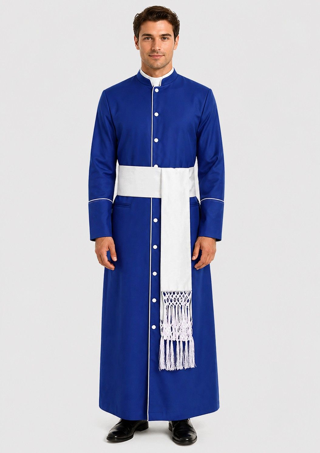 Man wearing a blue robe with a white sash on a plain background