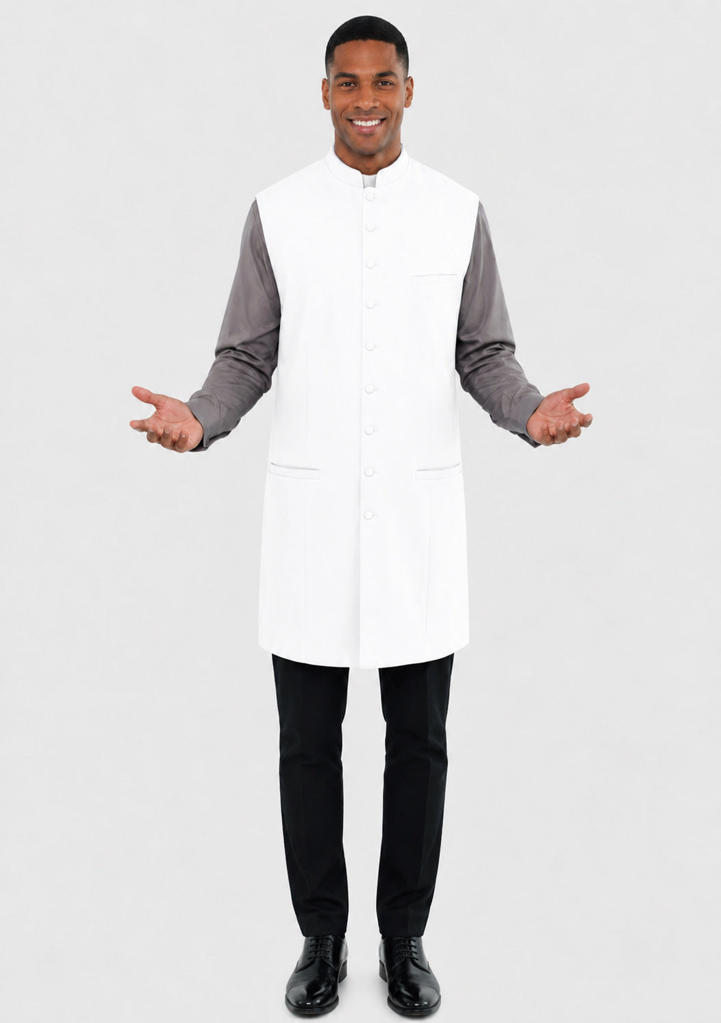 Man wearing a white vest over a gray long-sleeve shirt on a light gray background
