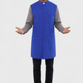 Man wearing a blue vest over a gray shirt on a white background