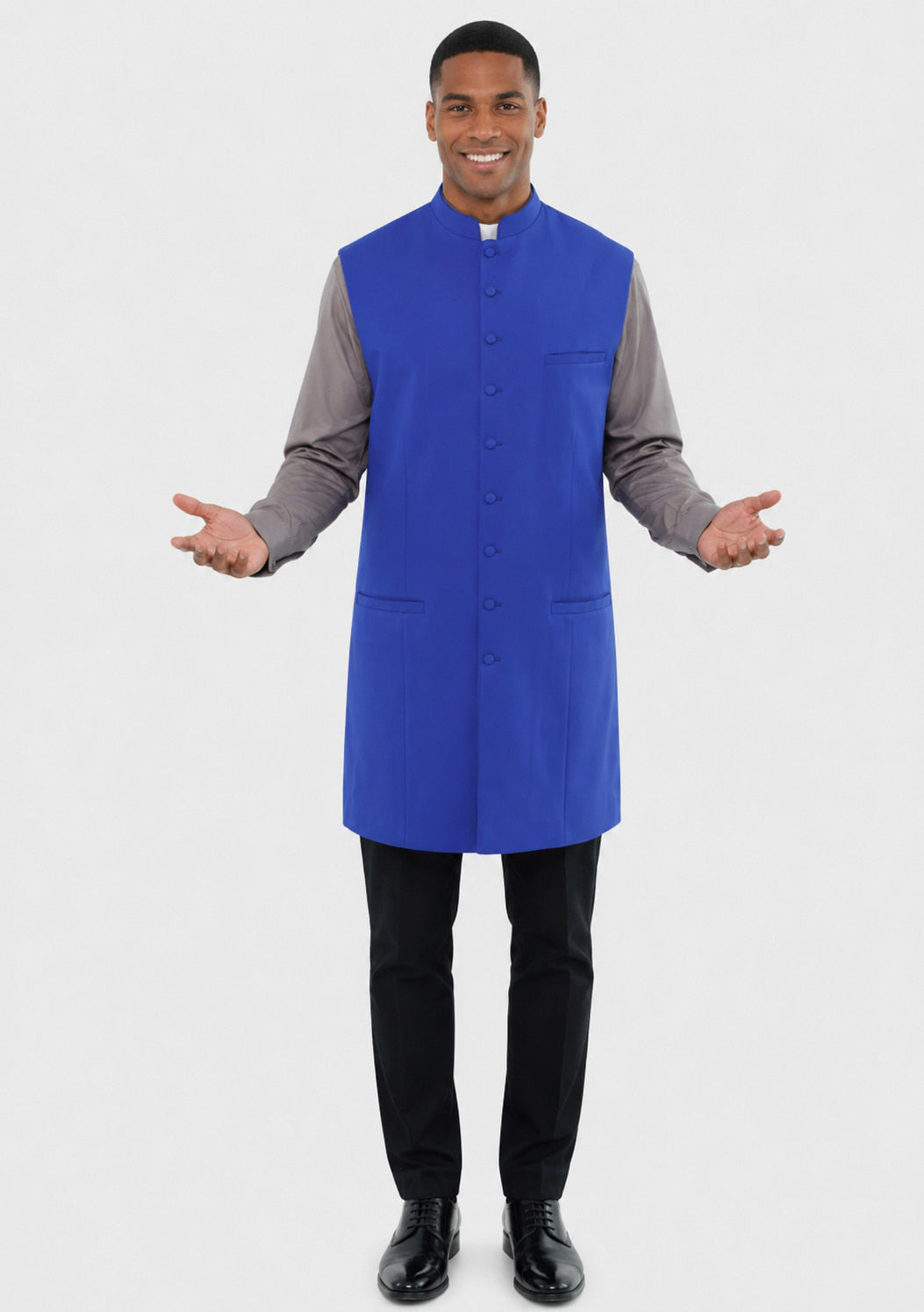Man wearing a blue vest over a gray shirt on a white background