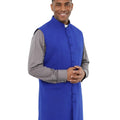 Man wearing blue vest on white background.