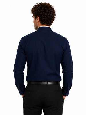 Man wearing a navy long-sleeve clerical shirt on a white background