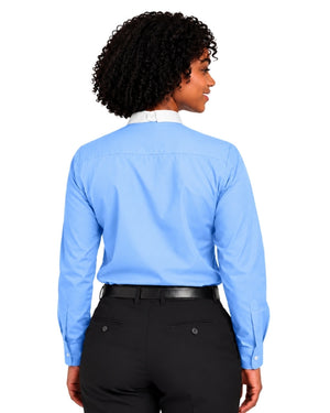 A woman with curly black hair is shown from the back wearing a light blue long-sleeve clerical shirt tucked into black trousers with a black belt, against a plain white background.