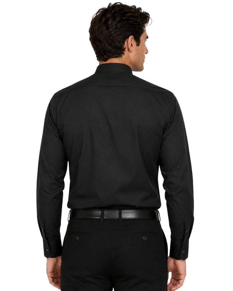 A man viewed from the back wearing a black long-sleeve clerical shirt tucked into black trousers with a black belt, against a plain white background.