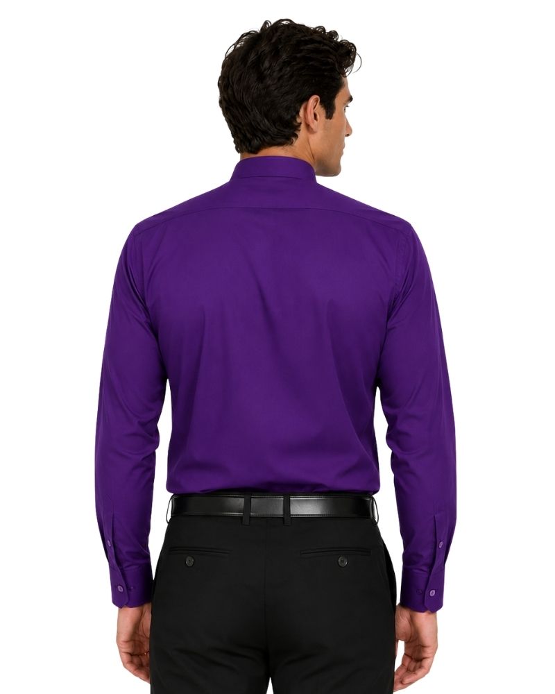 A man wearing a purple long-sleeve clerical shirt with a white collar tab, paired with a black belt and black trousers, standing against a plain white background.