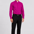 Man wearing a bright pink shirt and black pants on a white background