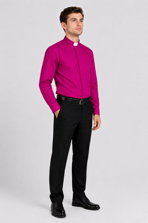 Man wearing a bright pink shirt with a collar and black pants on a white background