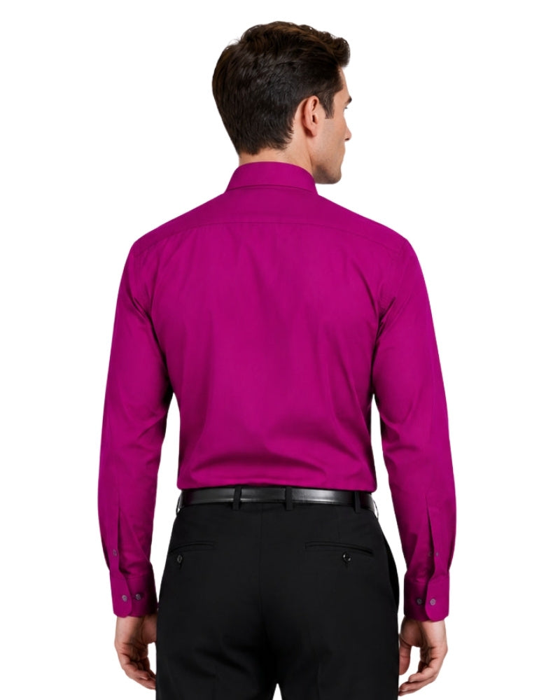 Man wearing a bright pink shirt and black pants on a white background