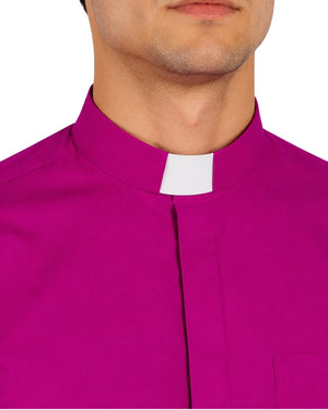 Man wearing a bright pink shirt and black pants on a white background