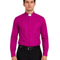 Man wearing a bright pink shirt and black pants on a white background