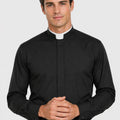 Man wearing a black clerical shirt with a white collar on a light gray background