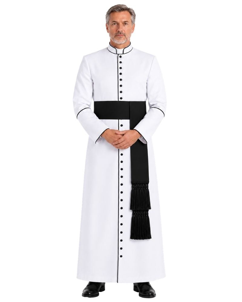 A man modeling White Clergy Cassock With Black Trim, a black waist sash, and black buttons, standing against a plain white background.