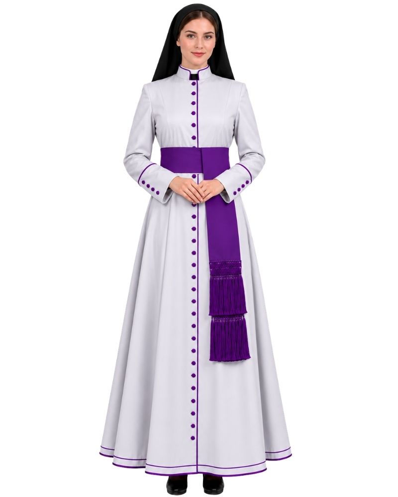 A woman modeling a White Clerical Cassock With Purple Trim with a wide purple waist sash, purple trim details, and a matching purple fringed drape, set against a plain white background.