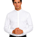 A man wearing a white long-sleeve clerical shirt with a unique stand-up collar and front button placket, paired with black trousers and a black belt, against a plain white background.