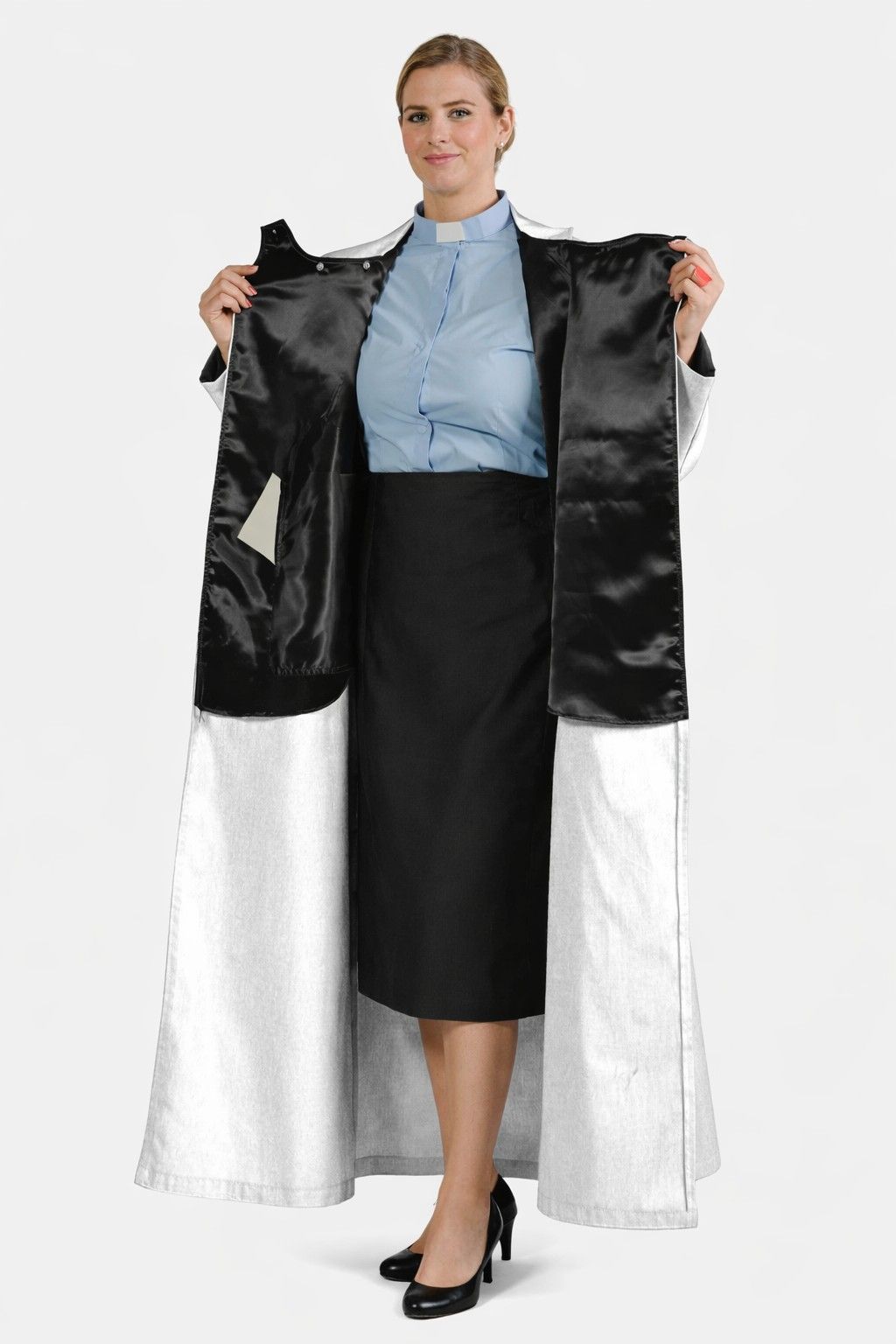 Woman holding a black and white dress with a plain background