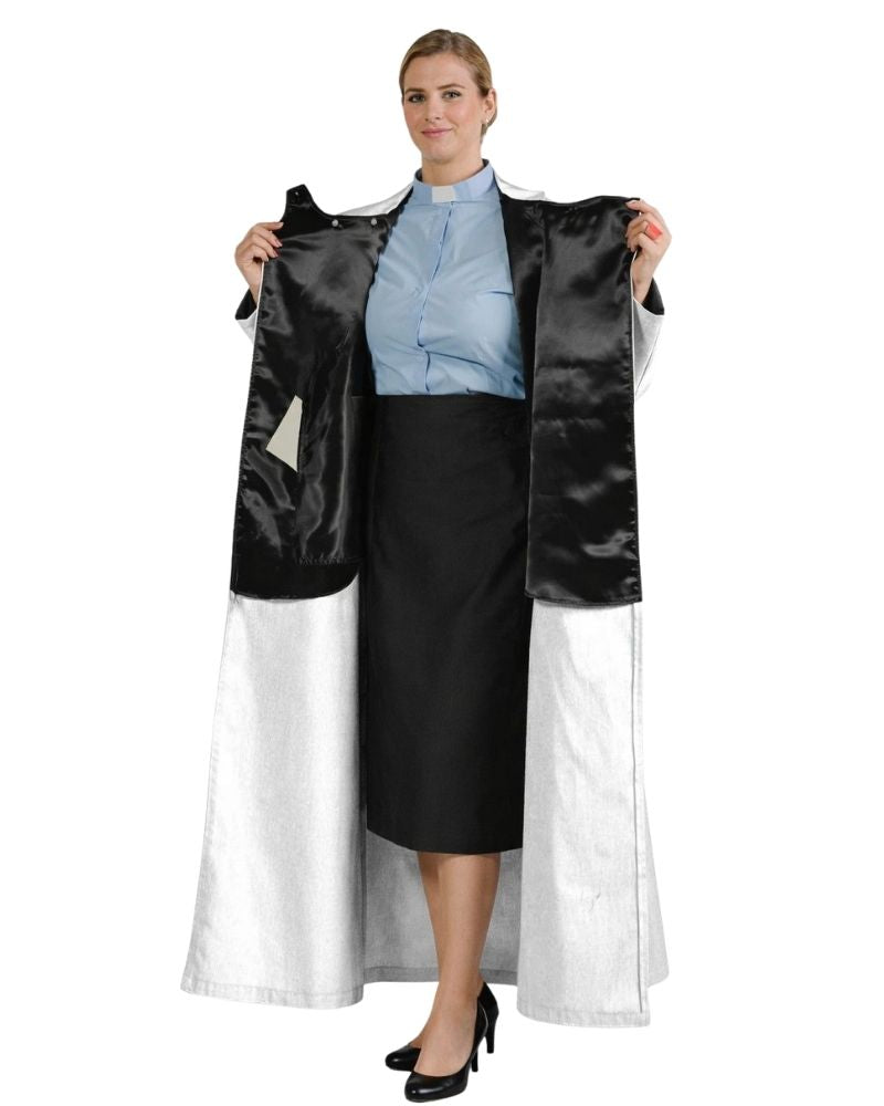 A woman modeling a black and white robe holding the open front panels to show the interior lining and full length. She is wearing a light blue collared shirt and a black skirt against a plain white background.