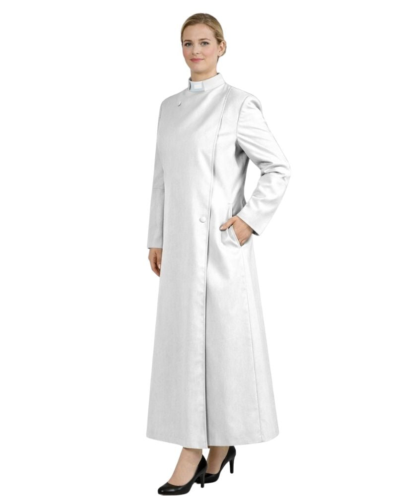 A woman modeling a long, white, high-neck, long-sleeved robe with a front button closure and side pockets, paired with black heels, against a plain white background.