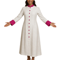 A woman modeling a long white cassock with bright pink trim at the collar, cuffs, and matching pink buttons down the front, shown against a plain white background.