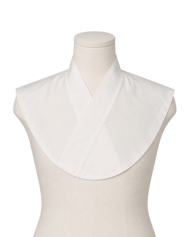 A white Amice displayed on a cream mannequin torso against a plain white background.