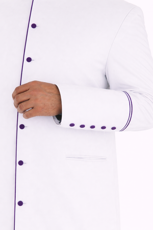White cassock with purple accents worn by a man