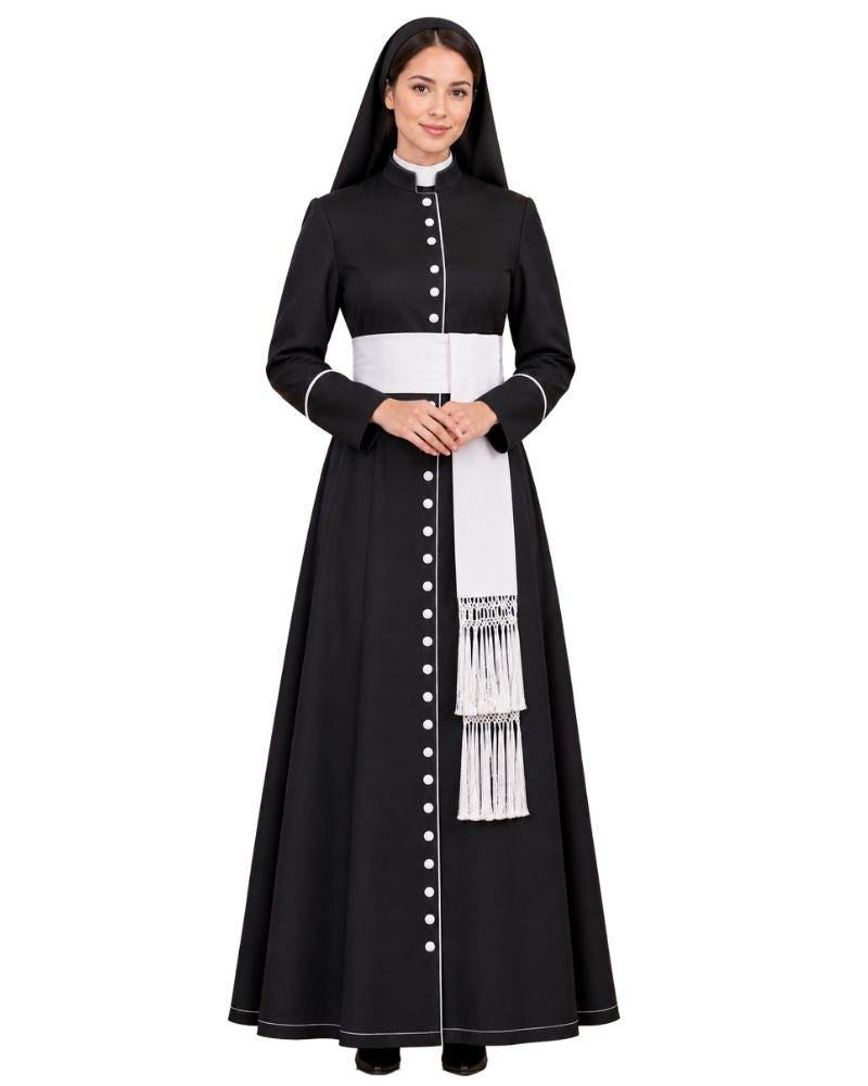 A woman modeling a  Black Clergy Cassock with a white waistband, white vertical button placket, and a white sash with fringe, photographed against a plain white background.