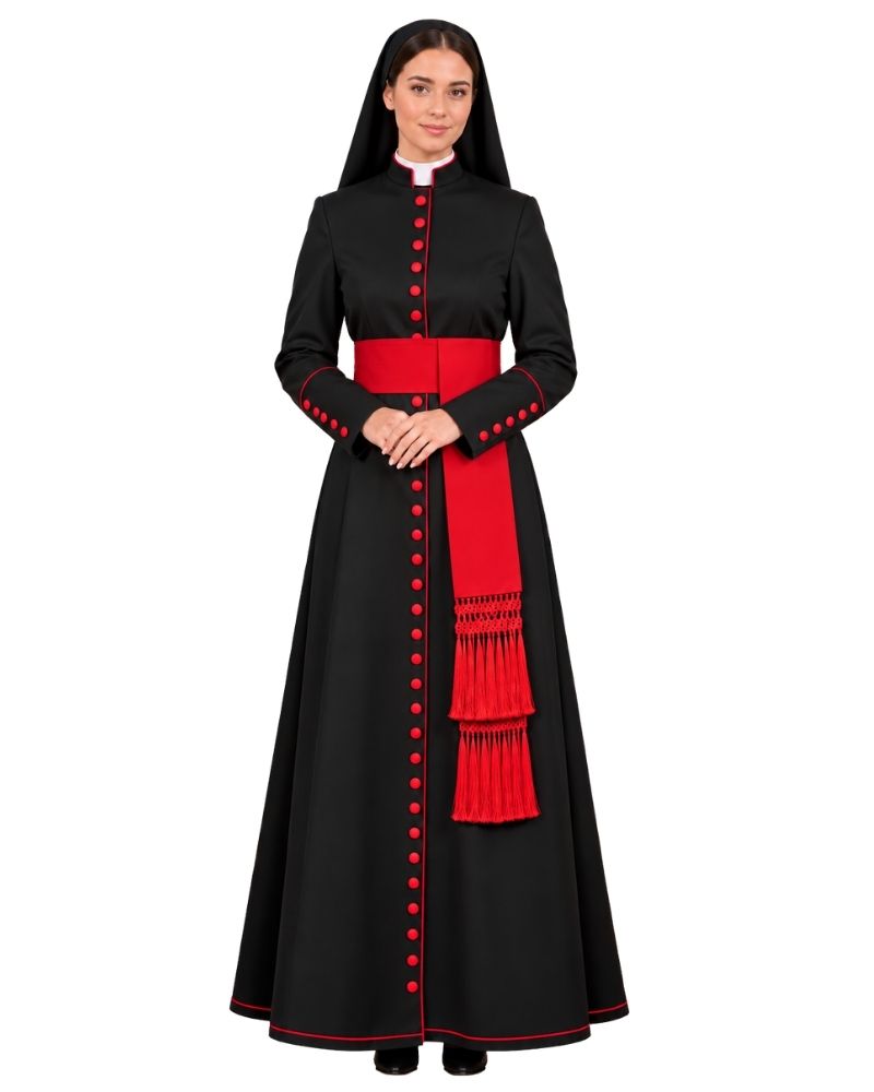 A woman modeling a Cardinal Black Cassock With Scarlet Piping with a high collar, red button details, a wide red waist sash, and a matching red draped scarf with fringe, set against a plain white background.