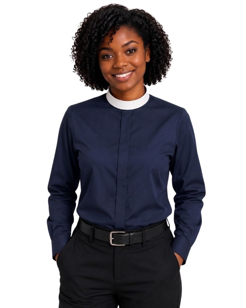 A woman with curly black hair wearing a navy blue long-sleeve clerical shirt with a white mock neck collar, paired with black trousers and a black belt, against a plain white background.