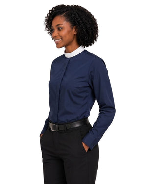 A woman wearing a navy blue long-sleeve clerical shirt with a contrasting white mock neck collar, paired with black trousers and a black belt, shown against a plain white background.
