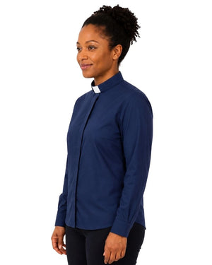 A woman wearing a navy blue long-sleeve clerical shirt with a white collar tab, shown in profile against a plain white background.