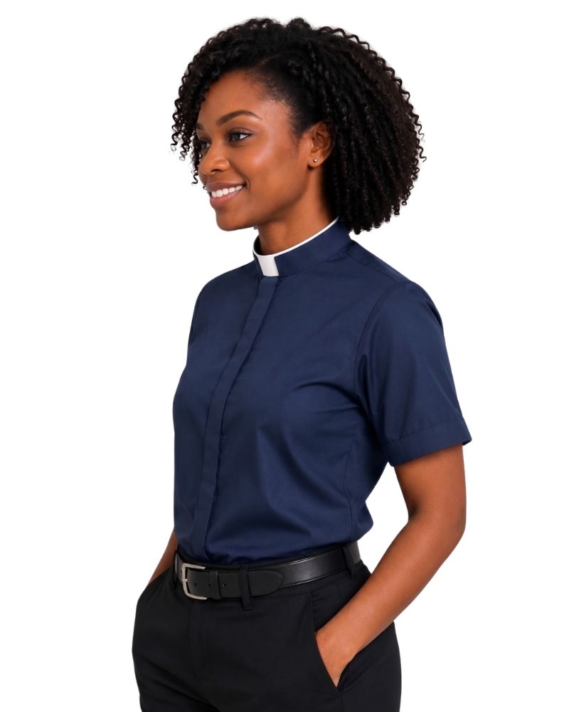 A woman modeling a navy blue short-sleeve clerical shirt with a white collar, paired with black trousers and a black belt, against a plain white background.