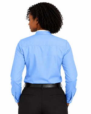A woman shown from the back wearing a light blue long-sleeve clerical shirt tucked into black trousers with a black belt, against a plain white background.