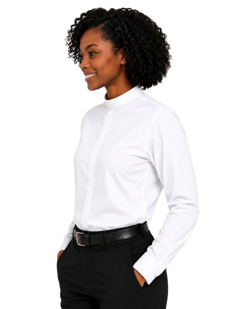 A woman with curly black hair is shown in profile wearing a white long-sleeve clerical shirt tucked into black trousers with a black belt, against a plain white background.