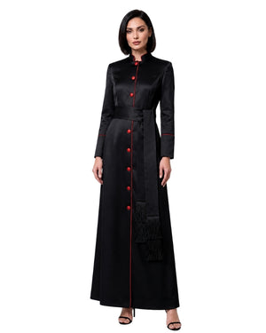 A woman modeling a long black satin-like robe with red button accents and red piping details, photographed against a plain white background.